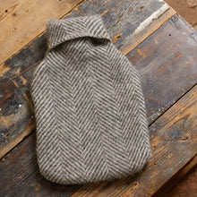 Load image into Gallery viewer, Gray herringbone patterned hot water bottle cover on a wooden surface
