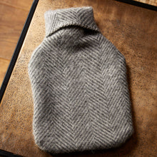 Load image into Gallery viewer, Gray herringbone-patterned hot water bottle on a wooden surface
